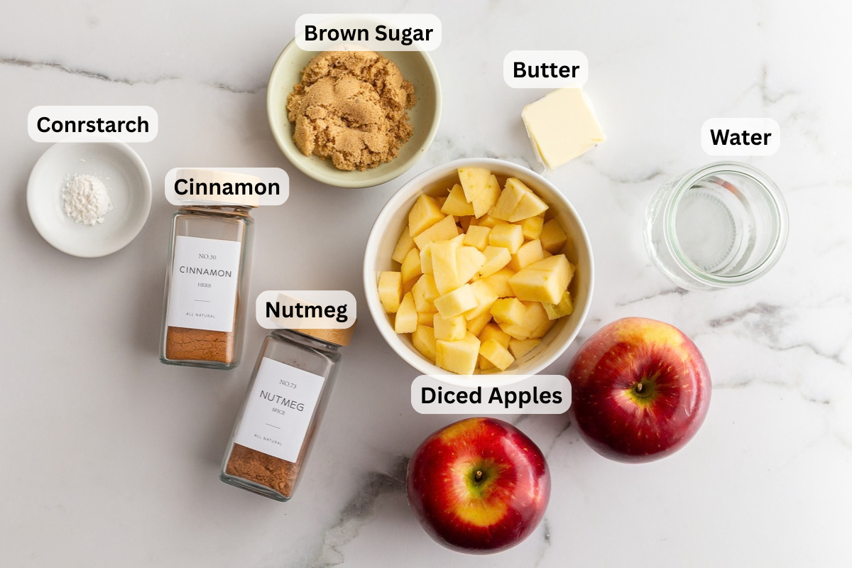 labeled ingredients needed to make sauteed apples including diced apples, brown sugar, water, cornstarch, cinnamon, and nutmeg