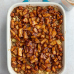 baked oatmeal topped with cinnamon apple chunks in a small teal baking dish