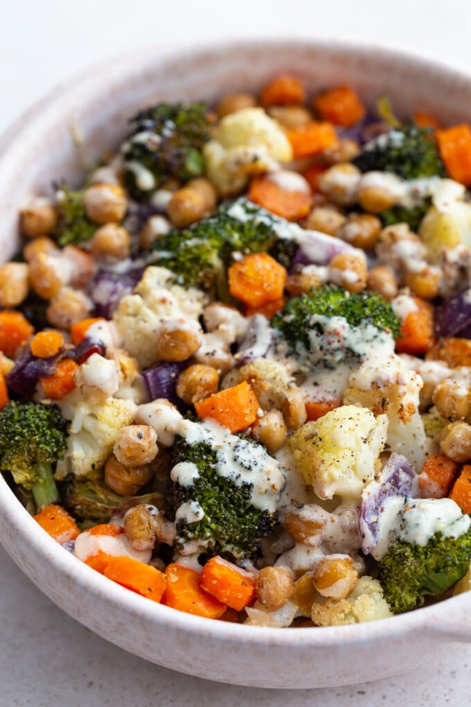 maple dijon roasted veggie bowls topped with dijon dressing