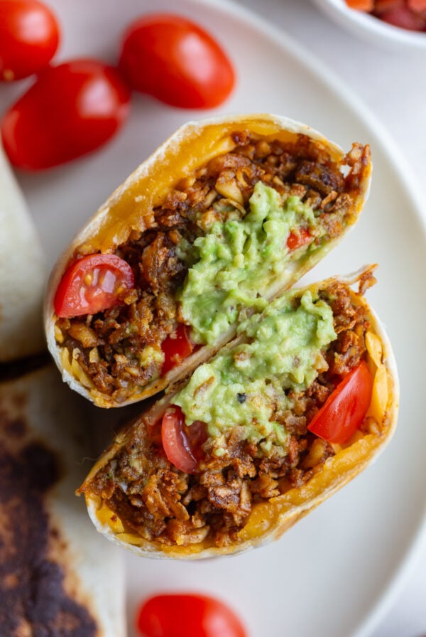 shredded tofu burritos filled with cheese, tomato and quacamole