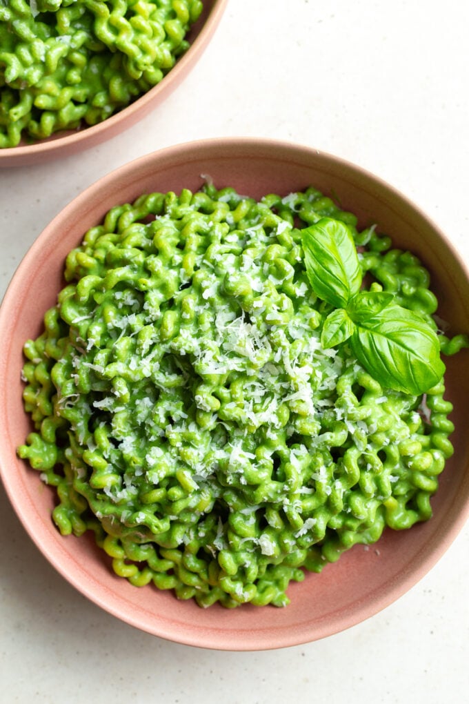 Green goddess pasta served in a pink bowl.