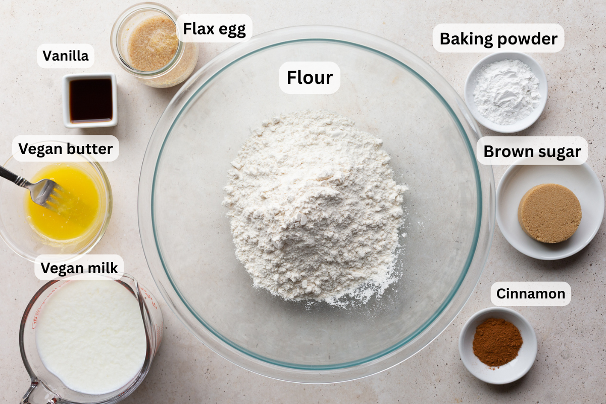 ingredients needed to make a vegan waffle recipe including flour, baking powder, vanilla, brown sugar, milk, and butter