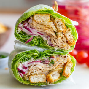 tofu lettuce wraps cut in half and stacked on top of each other so you can see the inside of the wrap