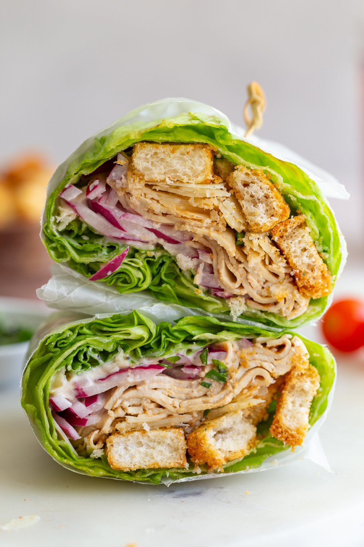 tofu lettuce wraps cut in half and stacked on top of each other so you can see the inside of the wrap
