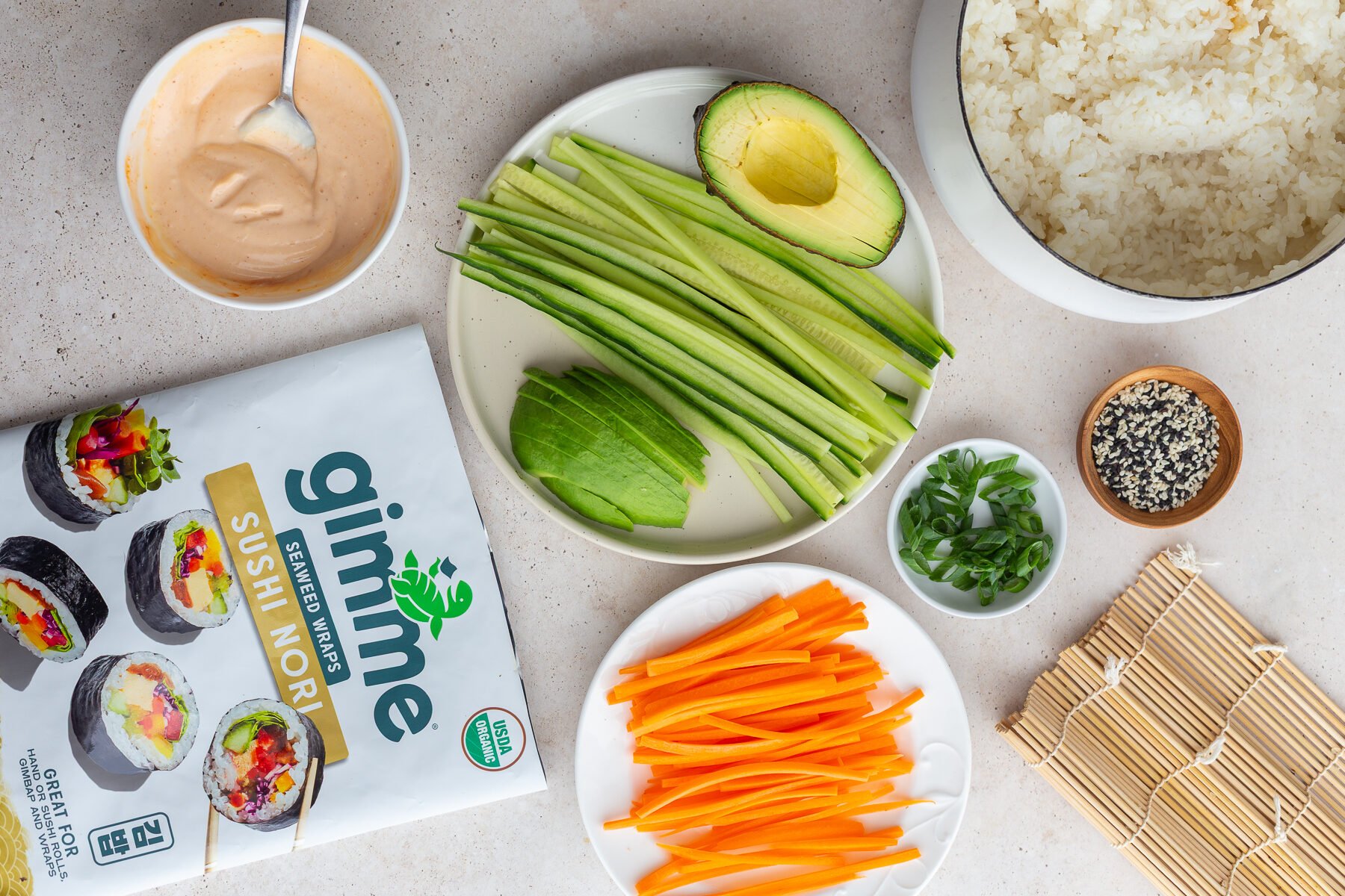 Bowl of rice near steps of avocado and carrots.