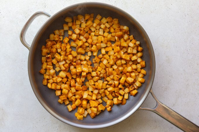 how to make vegetarian breakfast burritos: sautéing the hash browns
