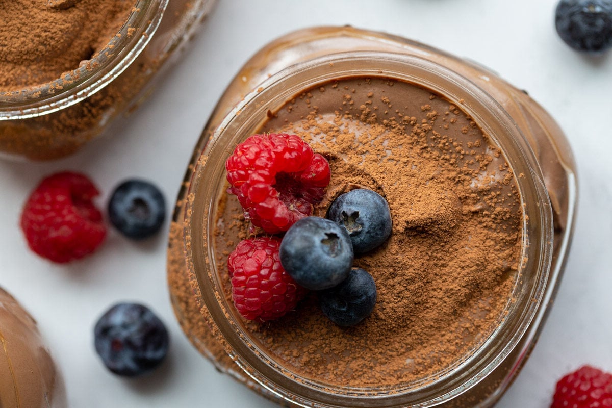 tofu pudding in a small glass jar with berries