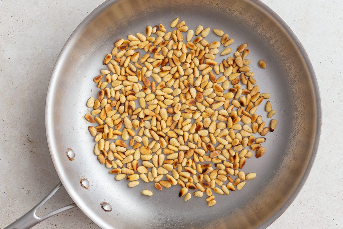 toasted pinenuts in a skillet