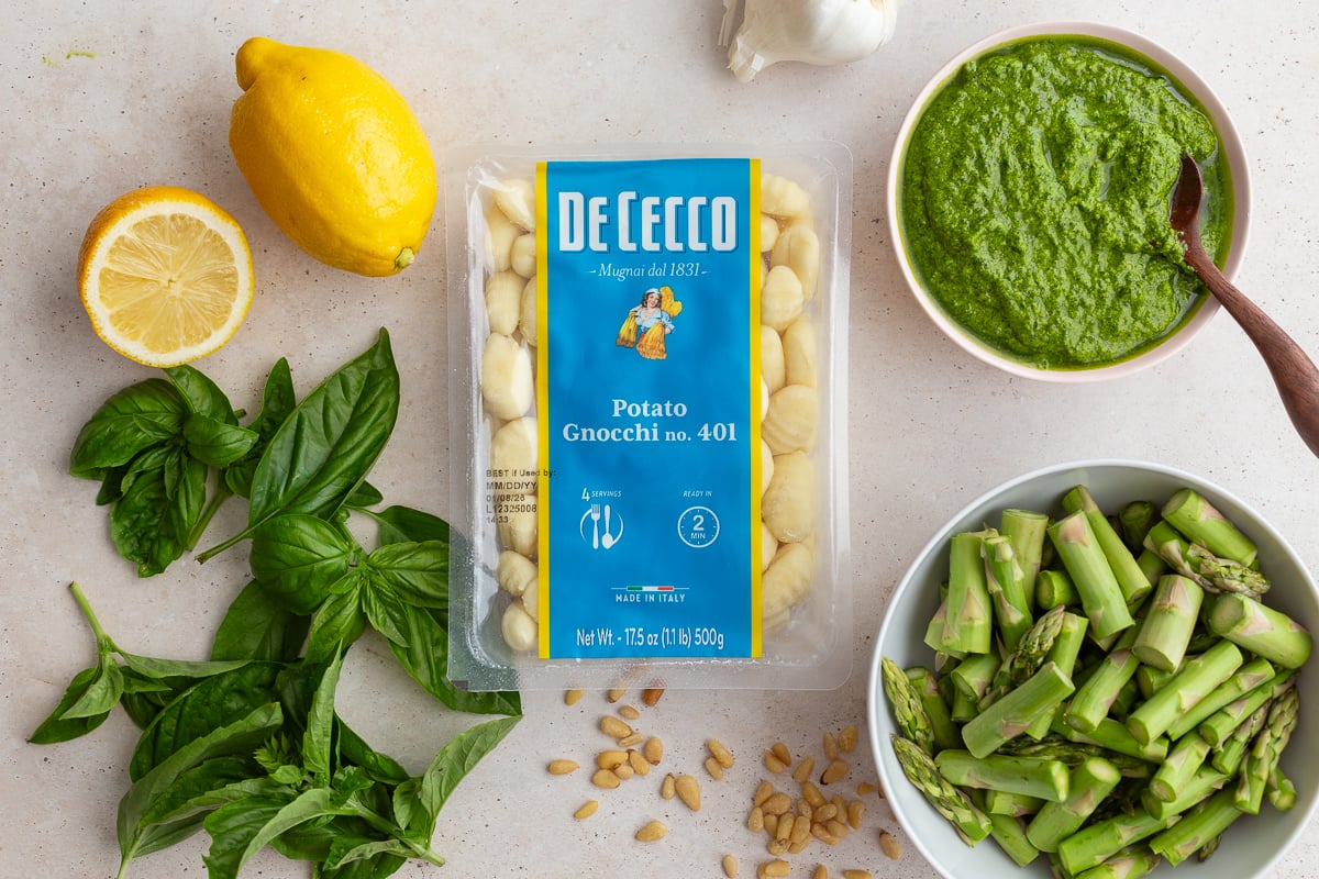 ingredients needed to make pesto gnocchi: storebought gnocchi, pesto, lemon juice, asparagus.