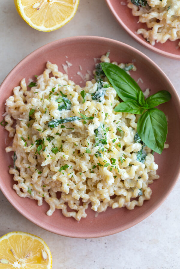 A bowl of creamy ricotta pasta topped with fresh herbs and parmesan cheese