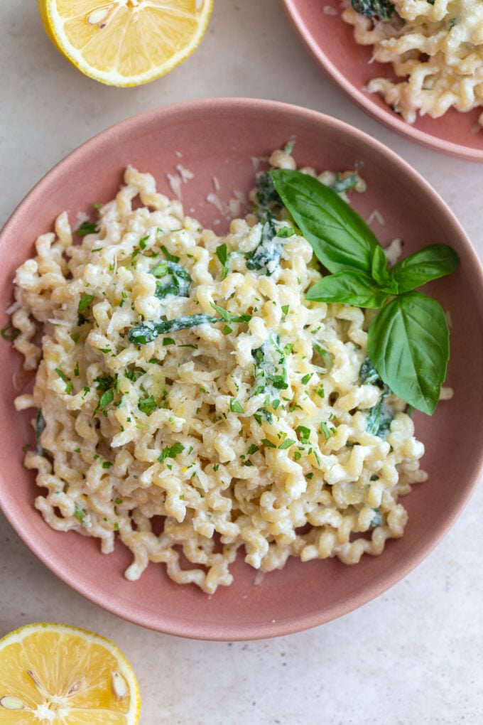 A bowl of creamy ricotta pasta topped with fresh herbs and parmesan cheese