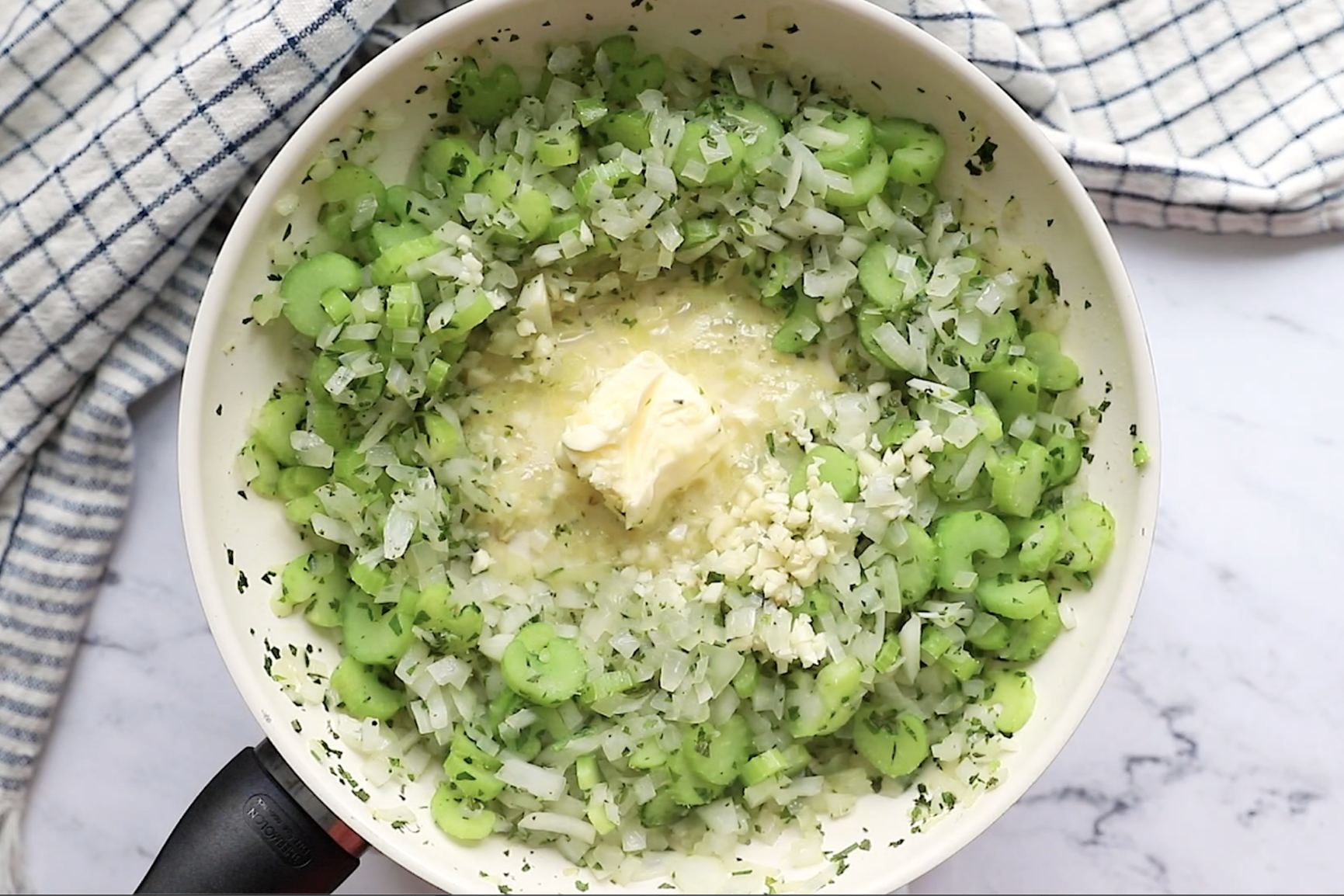 onion, celery and butter in a pan to make vegan stuffing