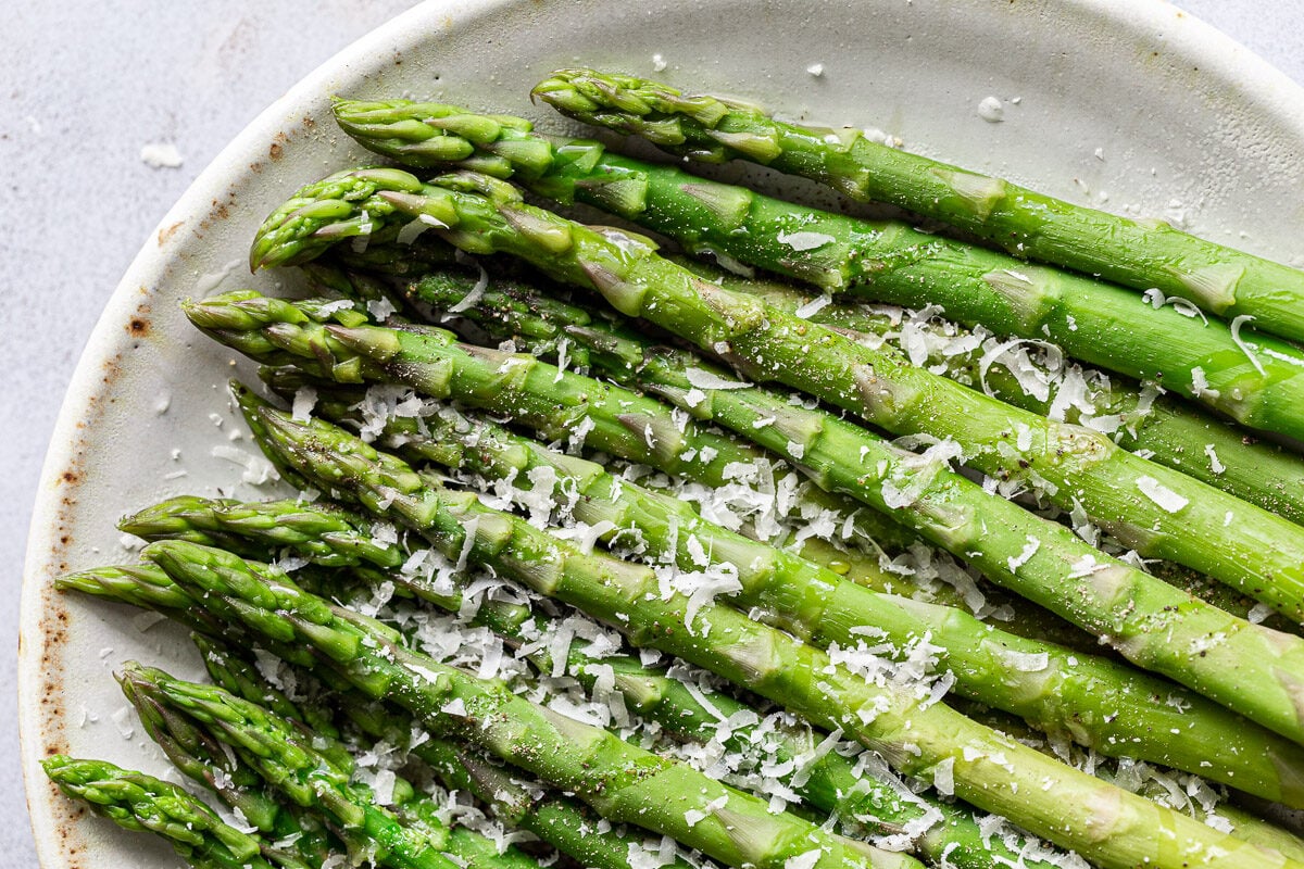 Parmesan asparagus on a white plate.