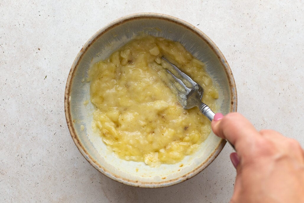 banana being mashed in a bowl