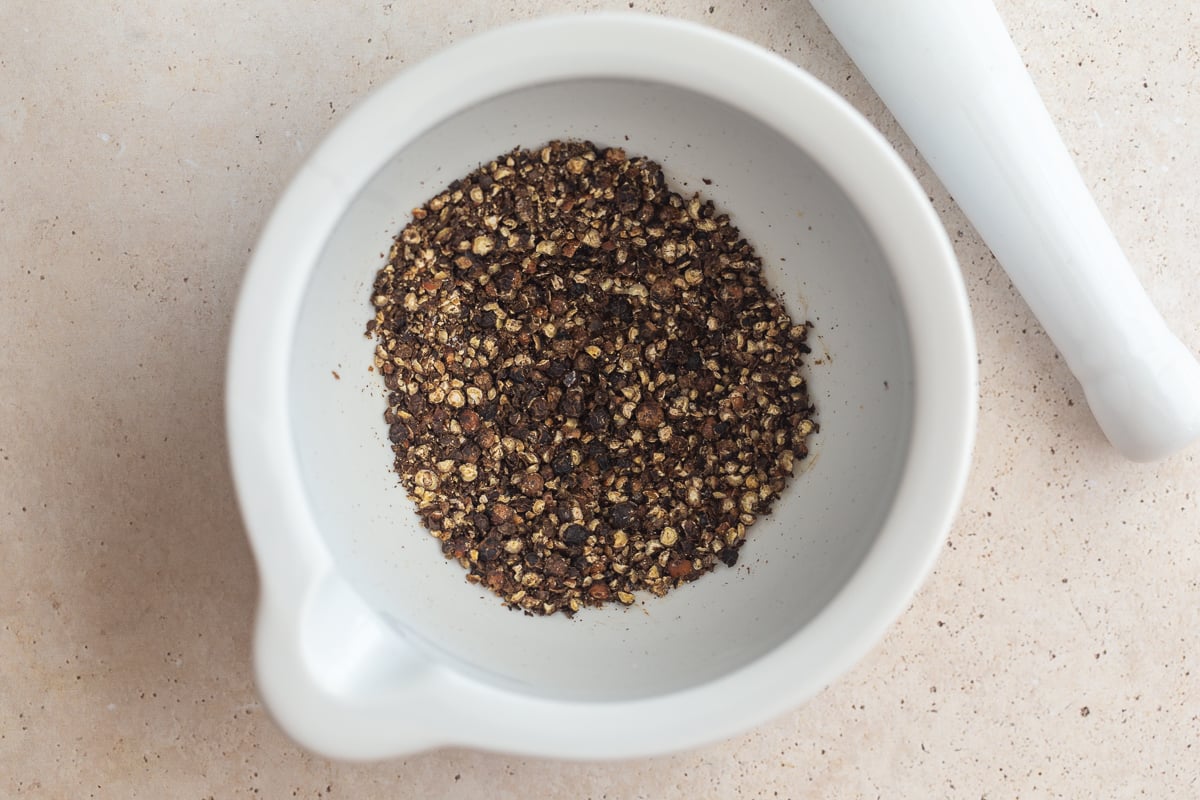 peppercorns ground up in a mortar and pestal