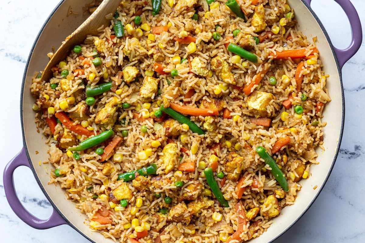 tofu fried rice with veggies in large purple skillet