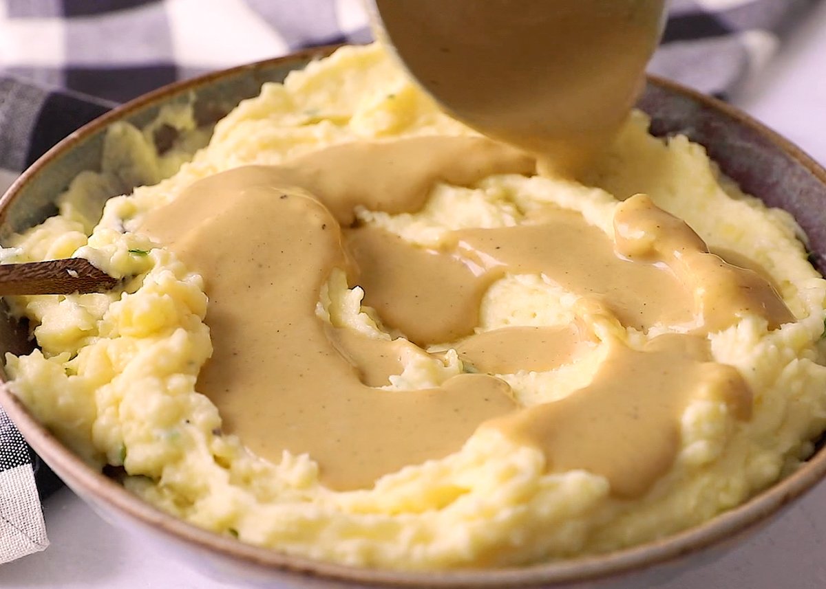 vegan gravy being poured on to mashed potatoes