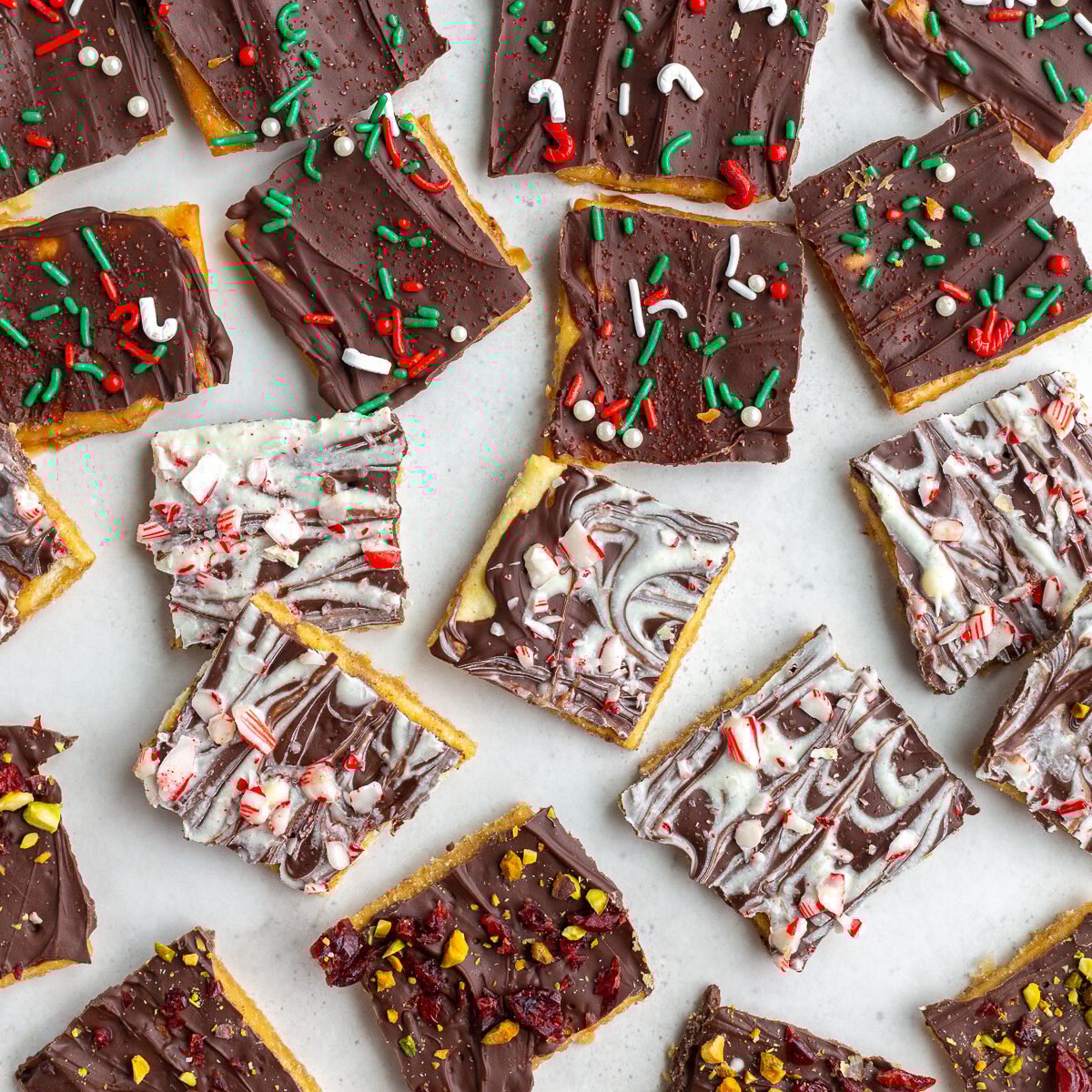 christmas crack recipe with pieces of cristmas toffee torn into small pieces and topped with various holiday toppings