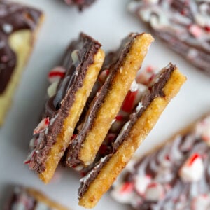 christmas cracker candy broken up into pieces and paying on it's side so you can see the cracker, toffee, and chocolate layers