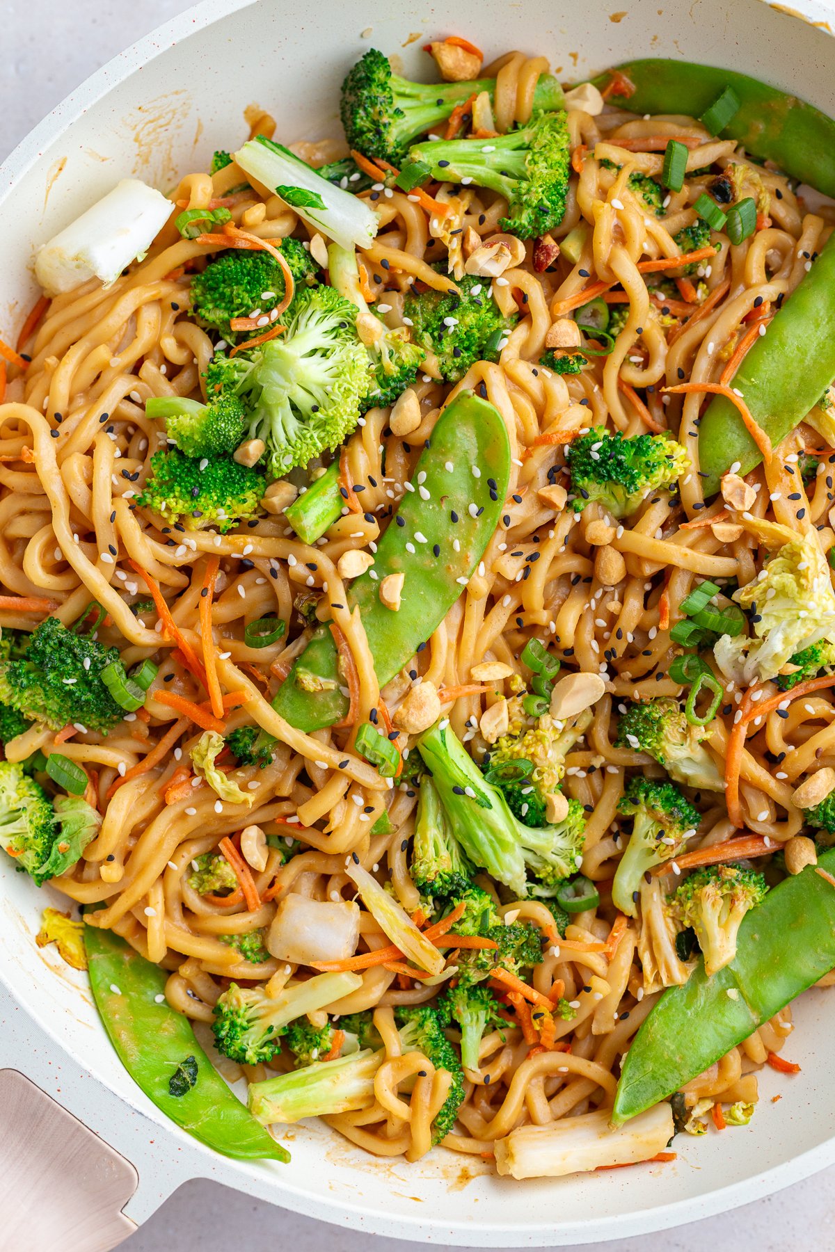 peanut tofu noodles with veggies in a large skillet