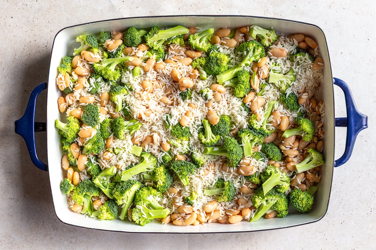 how to make cheesy broccoli rice casserole. riice, broccoli and beans in a casserole dish