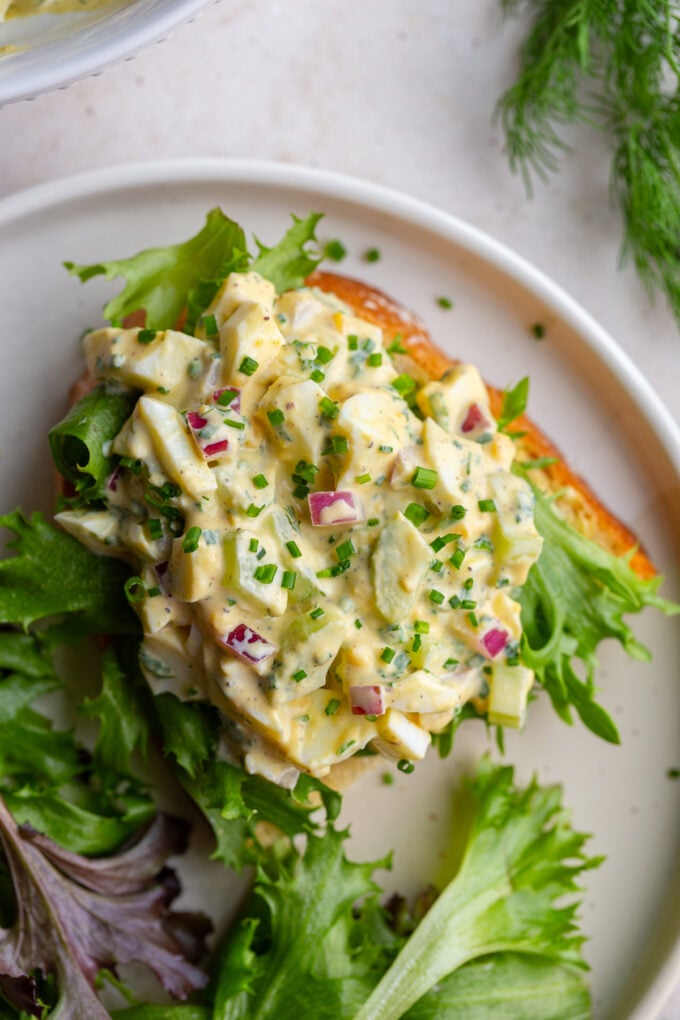 egg salad sandwich with greens on it