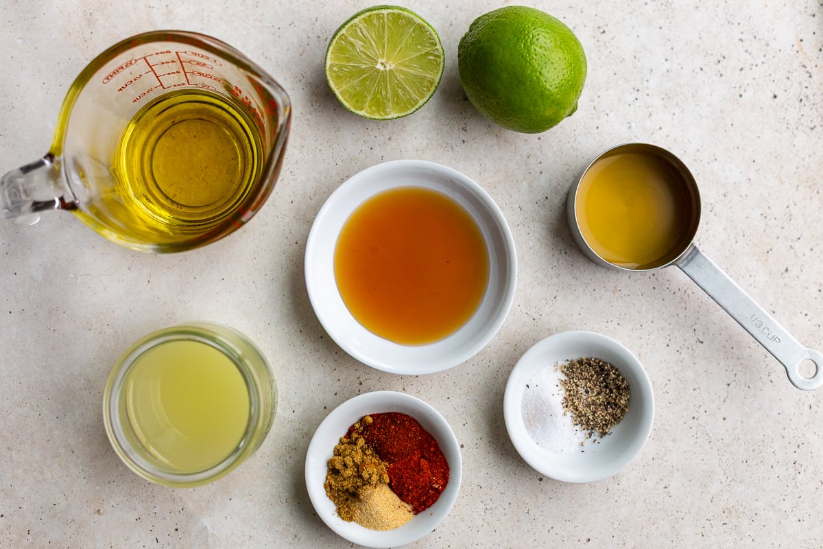 ingredients needed to make a southwestern vinaigrette including olive oil, honey, lime juice, spices, and salt and pepper