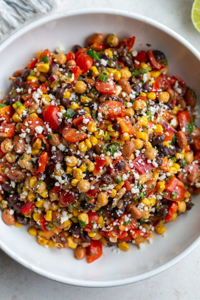 large bowl of Southwest bean salad filled with 3 types of beans and lots of veggies