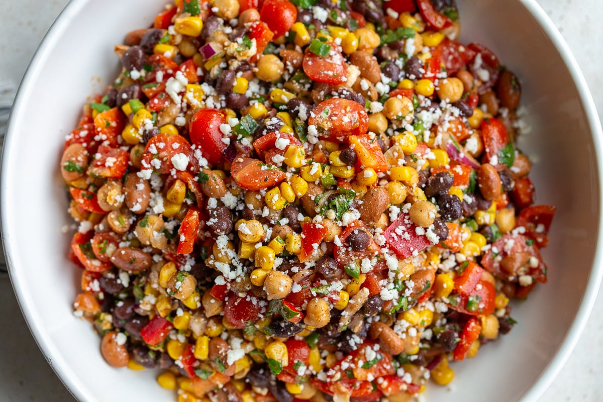 large bowl of Southwest bean salad filled with 3 types of beans and lots of veggies