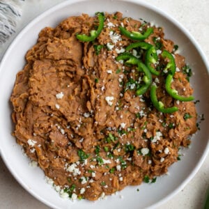 homemade refried beans in a large white bowl