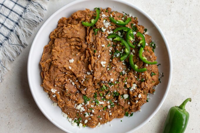 homemade refried beans in a large white bowl