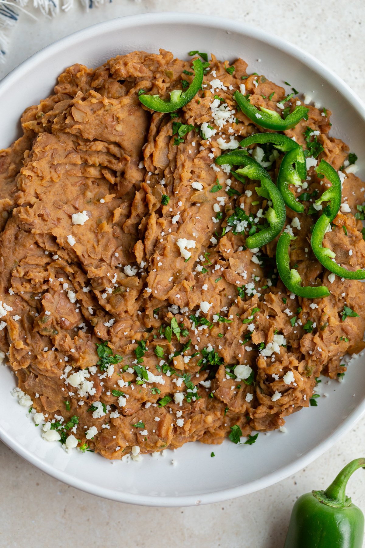 homemade refried beans in a large white bowl