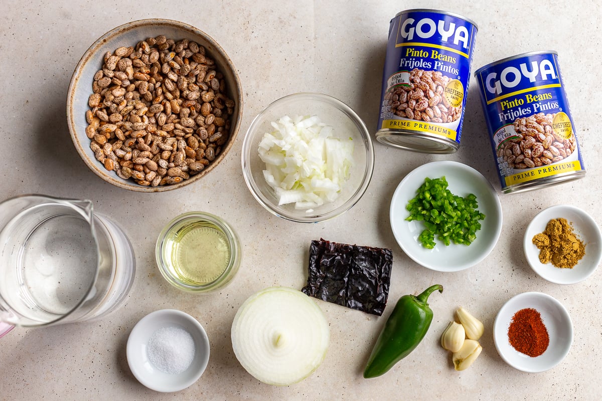 ingredients need to make this refried beans recipe including dried pinto beans, onion, jalapeno, water, and spices