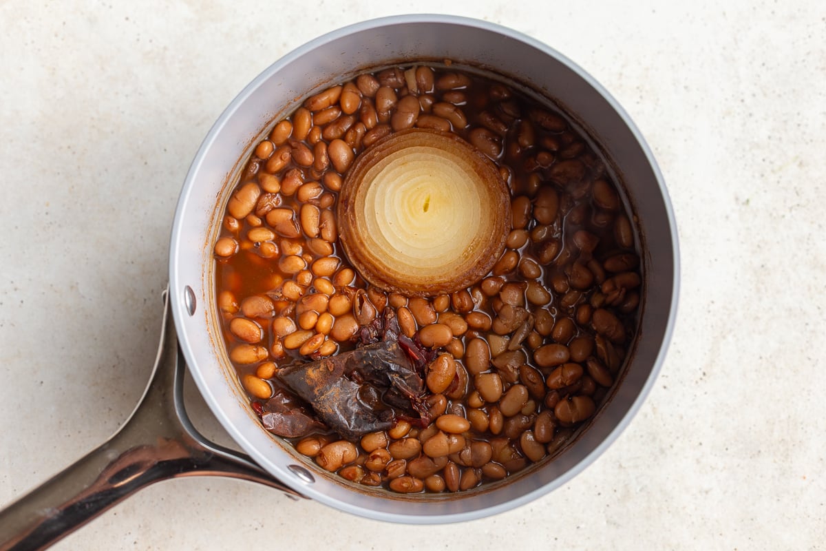 pinto beans cooked in a pot with onion and pepper