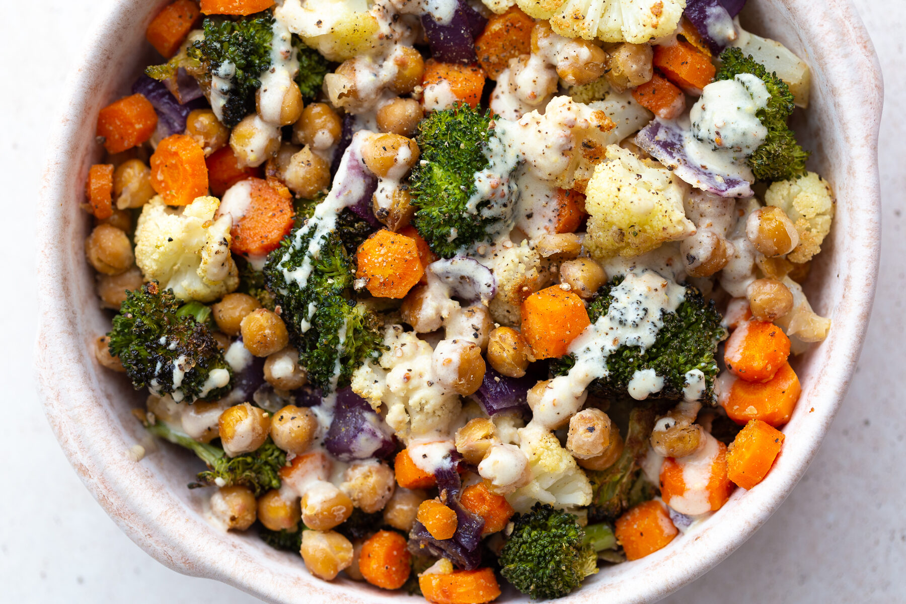 maple dijon roasted veggie bowls topped with dijon dressing
