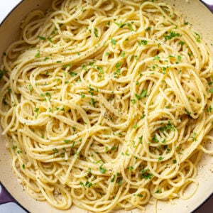 white wine pasta in a large skillet topped with fresh herbs