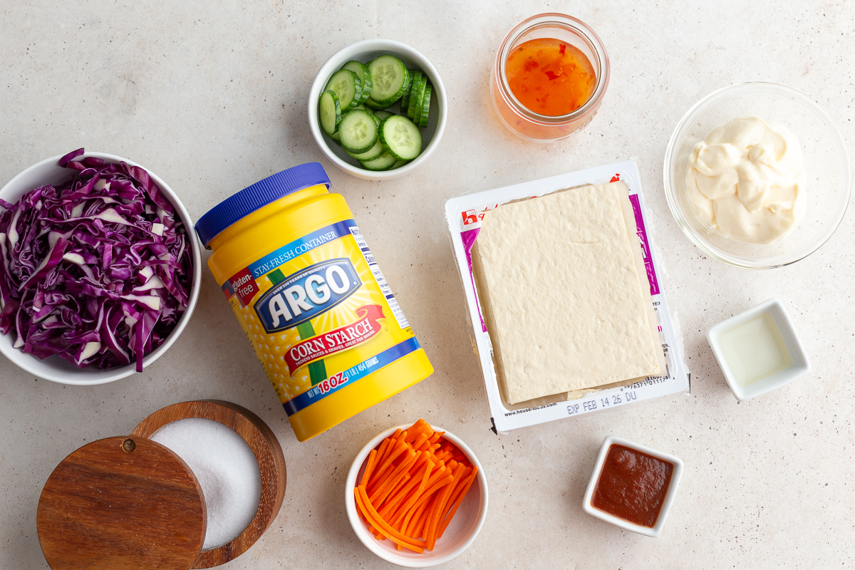 ingredients needed to make bang bang tofu including tofu, cornstarch, sweet chili sauce, mayo, etc