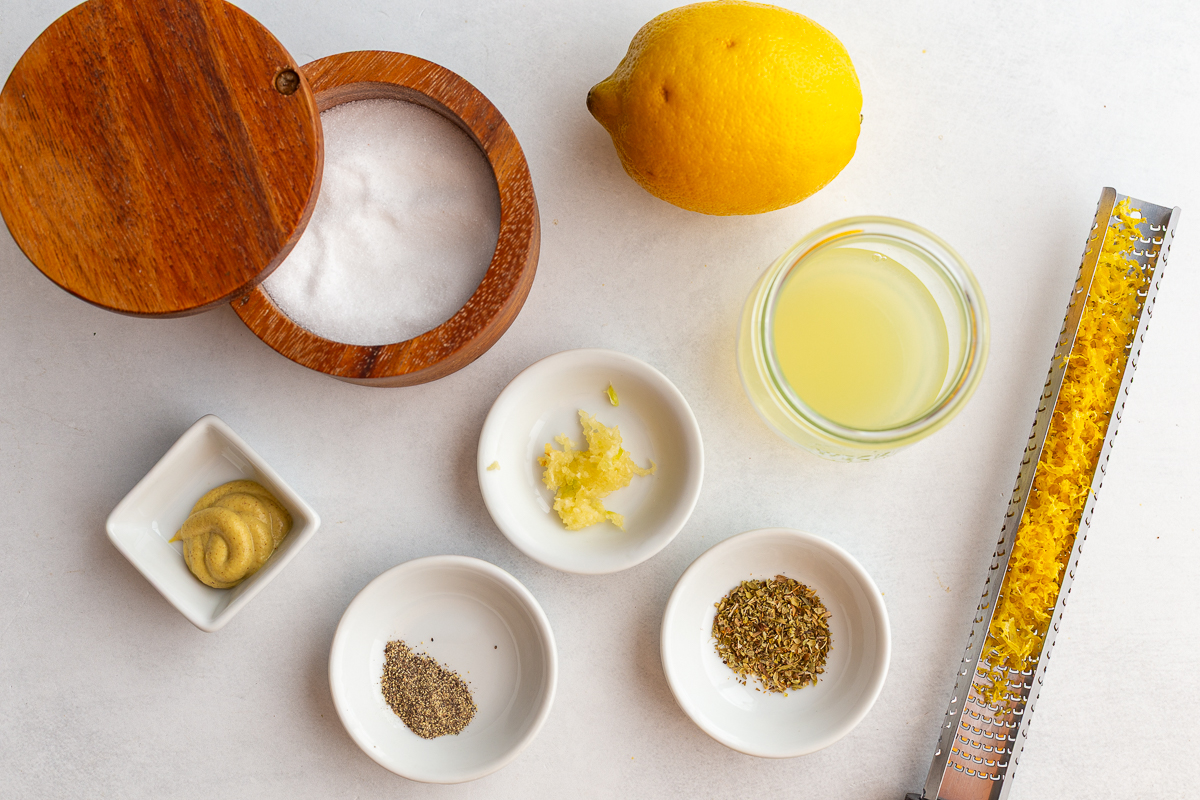 ingredients needed for a lemon Vinaigrette including olive oil, lemon, dijon mustard, salt, pepper, and dried oregano