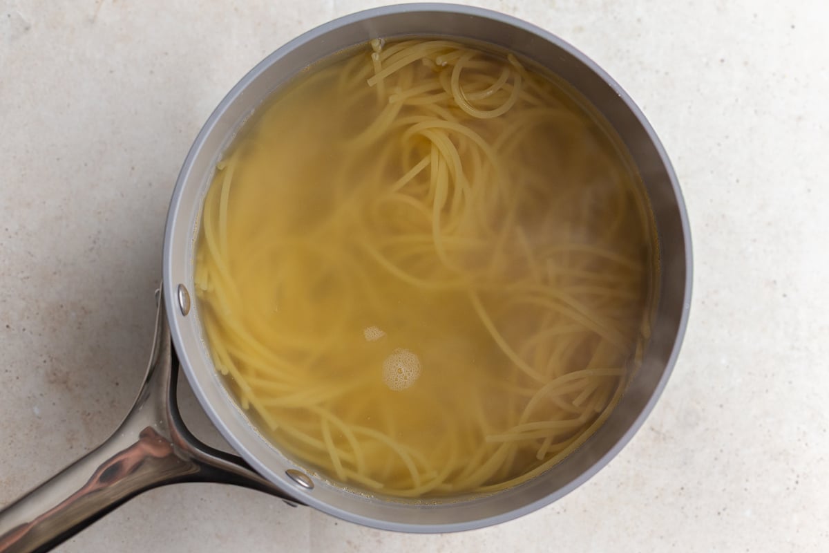 spaghetti cooked in a pot with water
