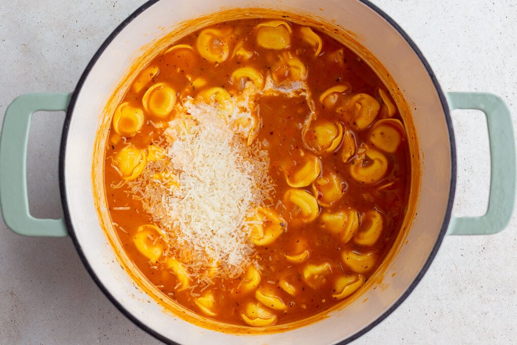 tortellini soup in a large pot with heavy cream poured in but not mixed yet