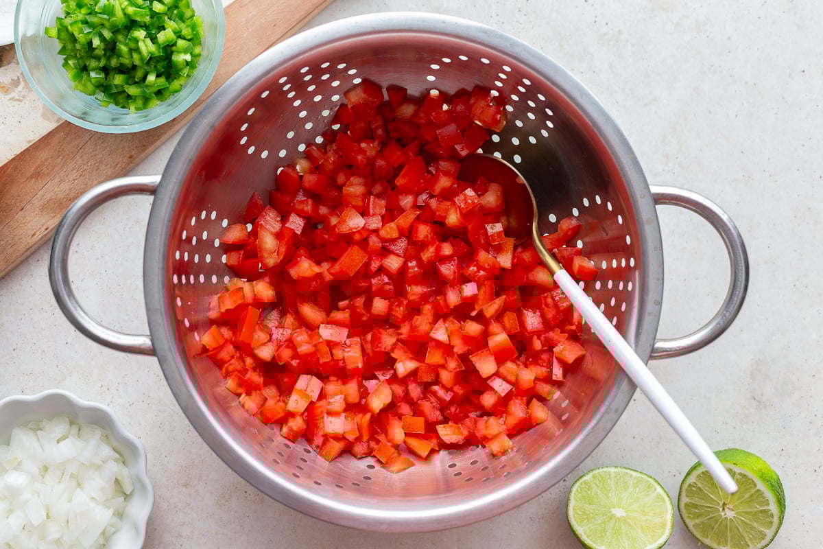 diced tomatoes in a colander draining the excess liquid