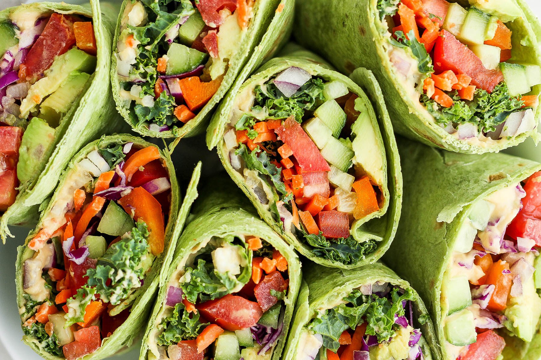 veggie wraps filled with hummus and rainbow veggies