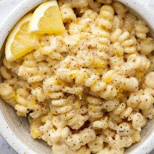 Creamy lemon pasta served in a white bowl.