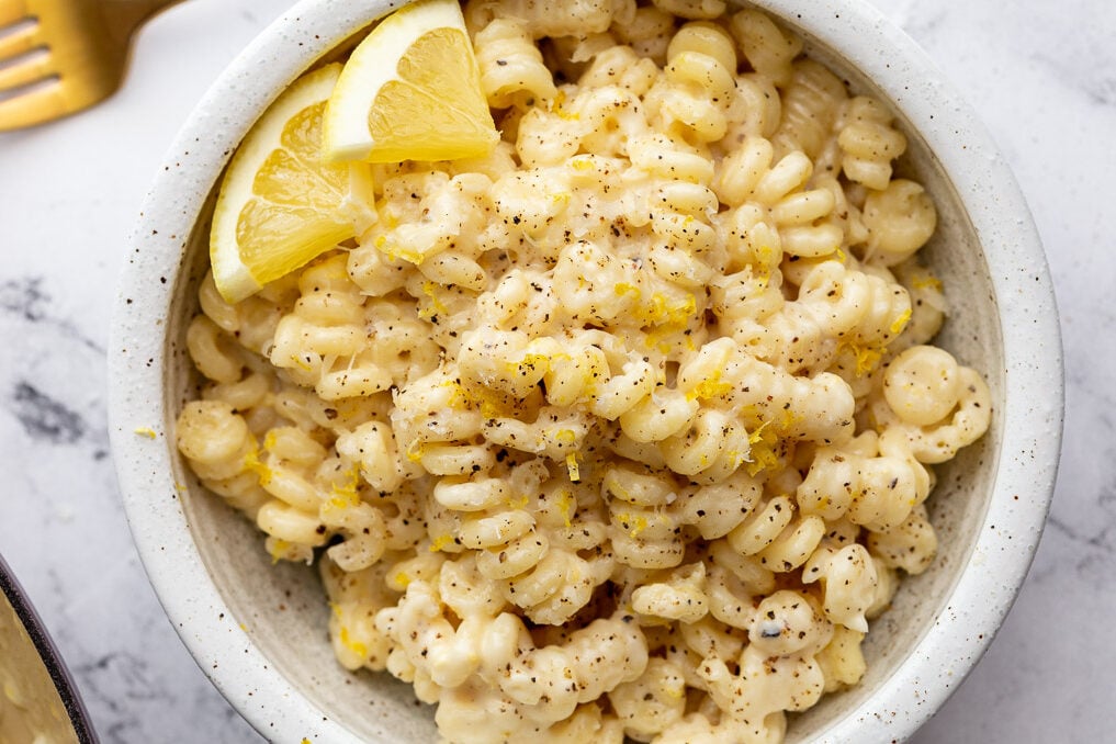Creamy lemon pasta served in a white bowl.