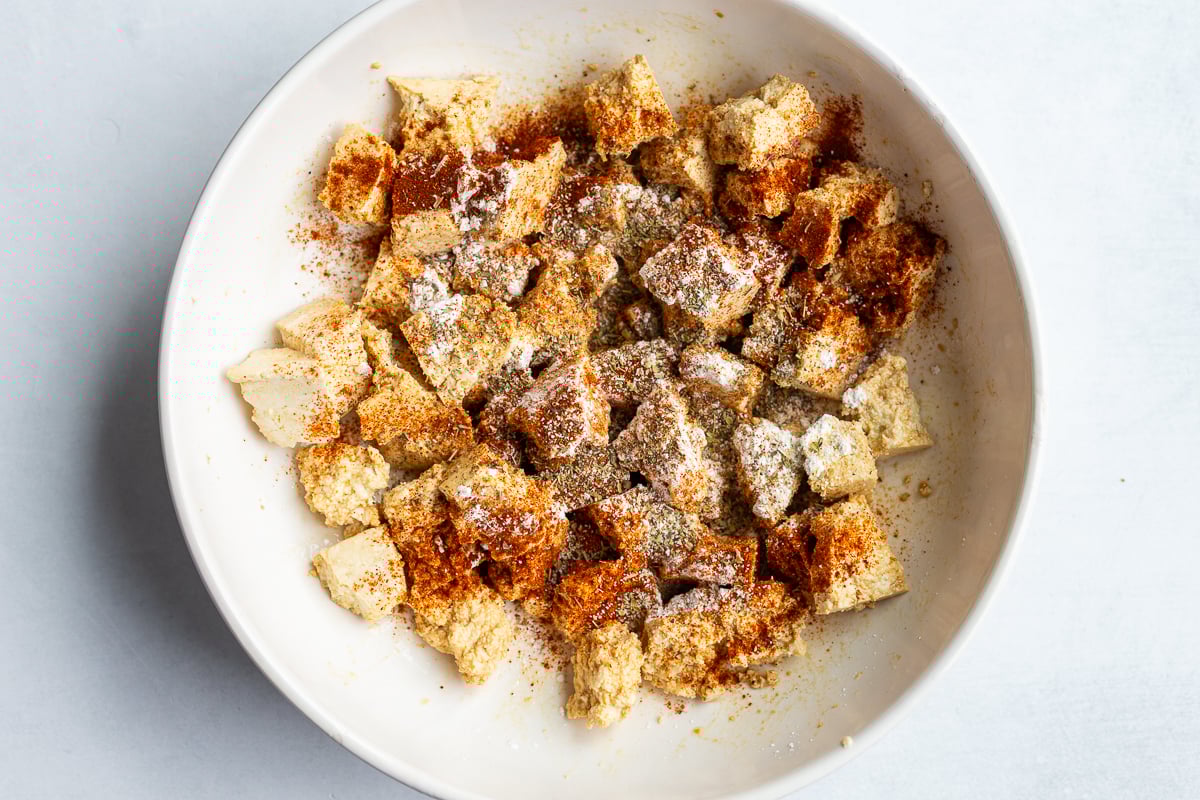 tofu chunks in a bowl with spices