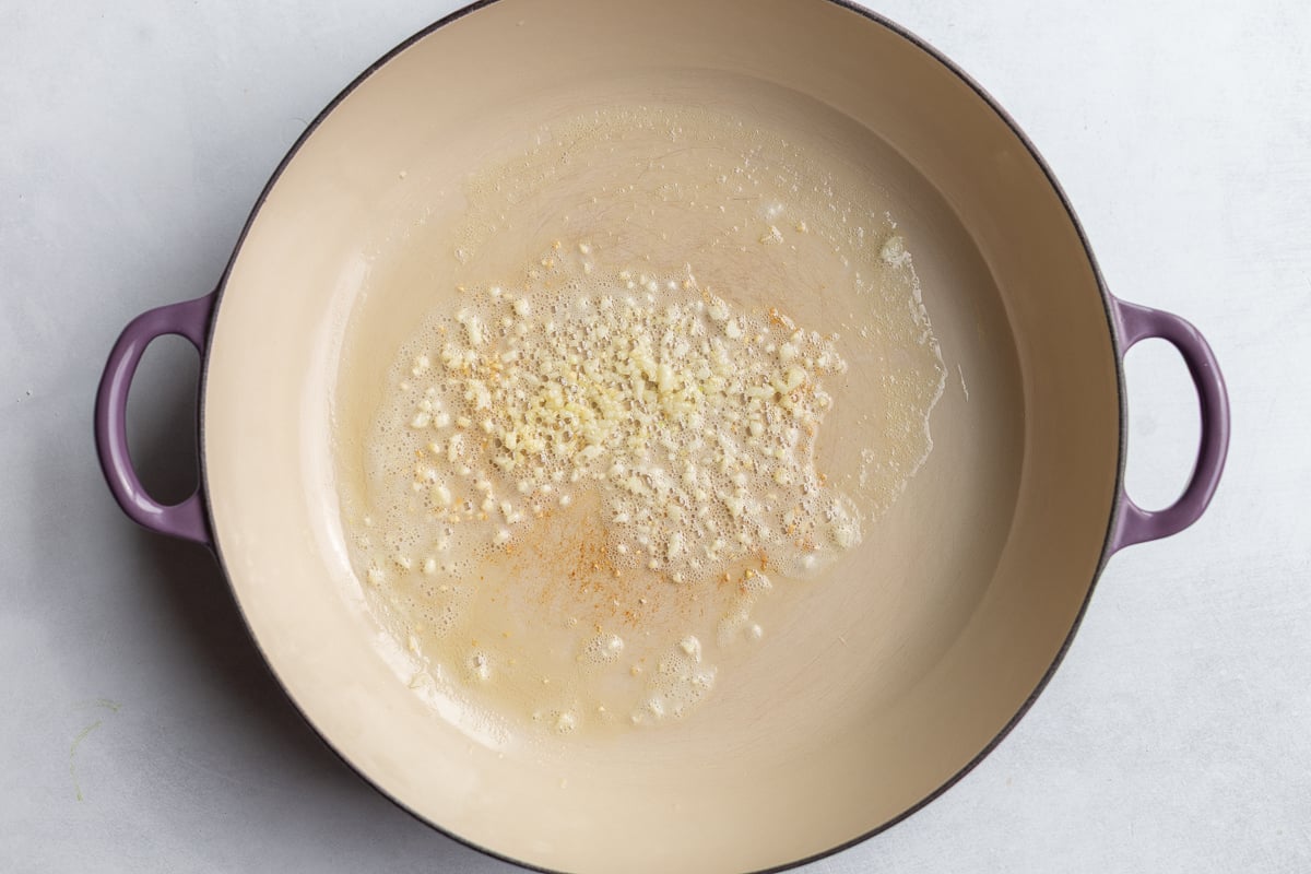 garlic sauteing in a large skillet