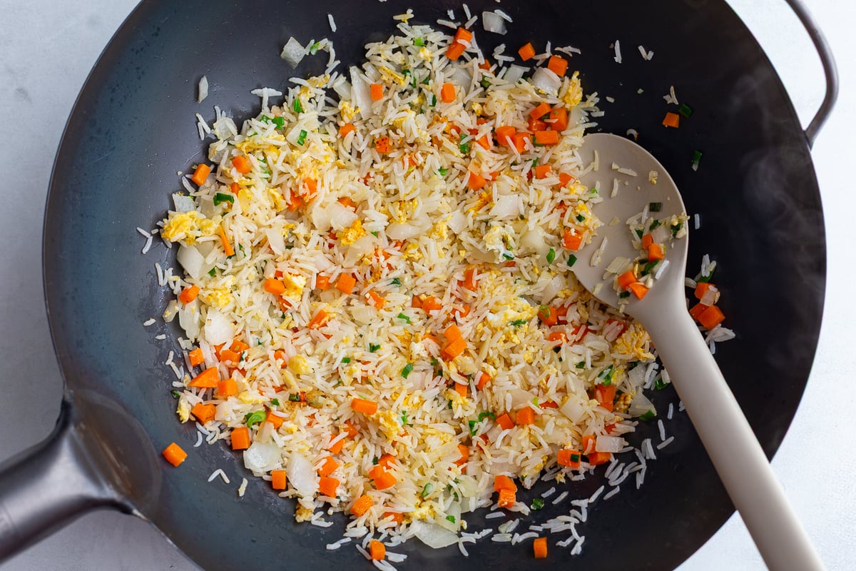 fried rice in a wok before it's been fully fried