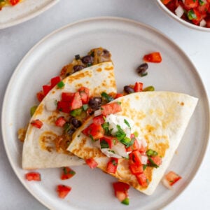 stack of vegetarian quesadillas with bell pepper, onion, cheese, and black beans