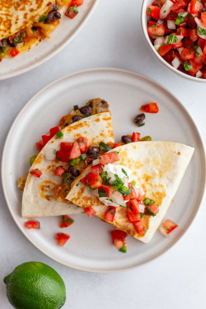 stack of vegetarian quesadillas with bell pepper, onion, cheese, and black beans