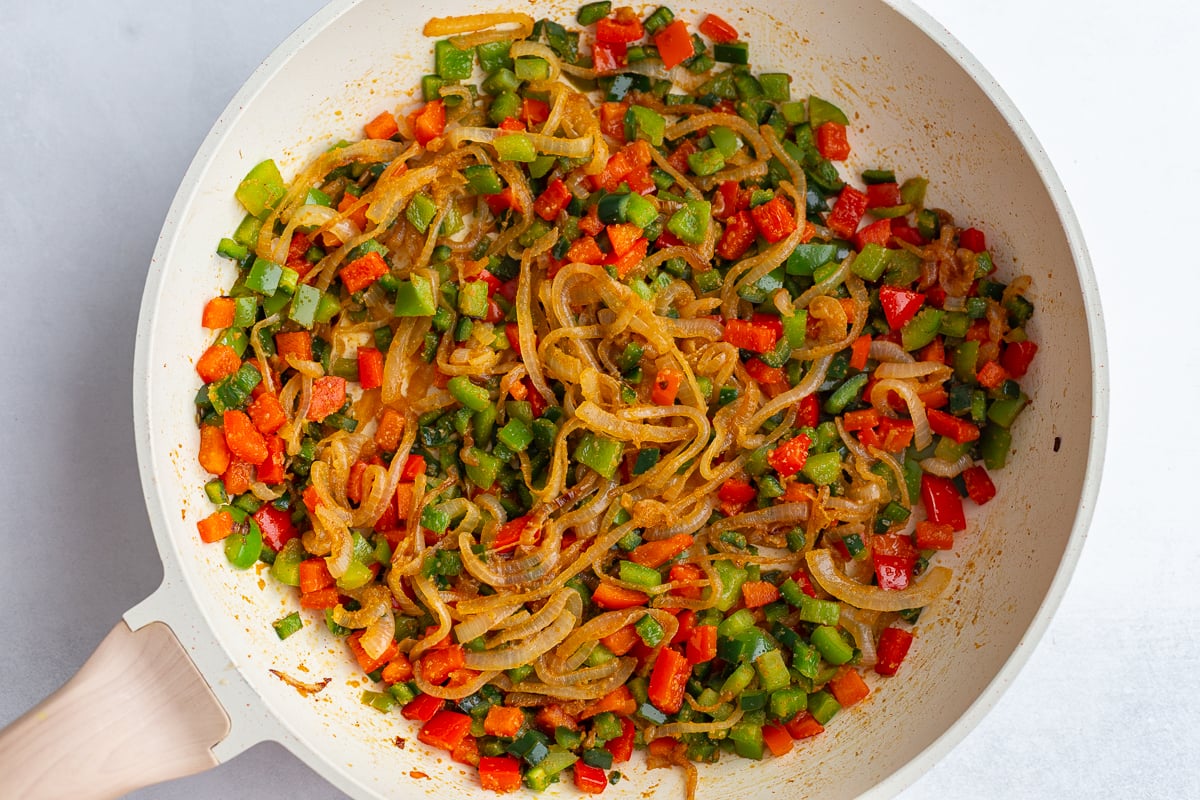 sauteed onion and bell pepper in a large skillet with black beans